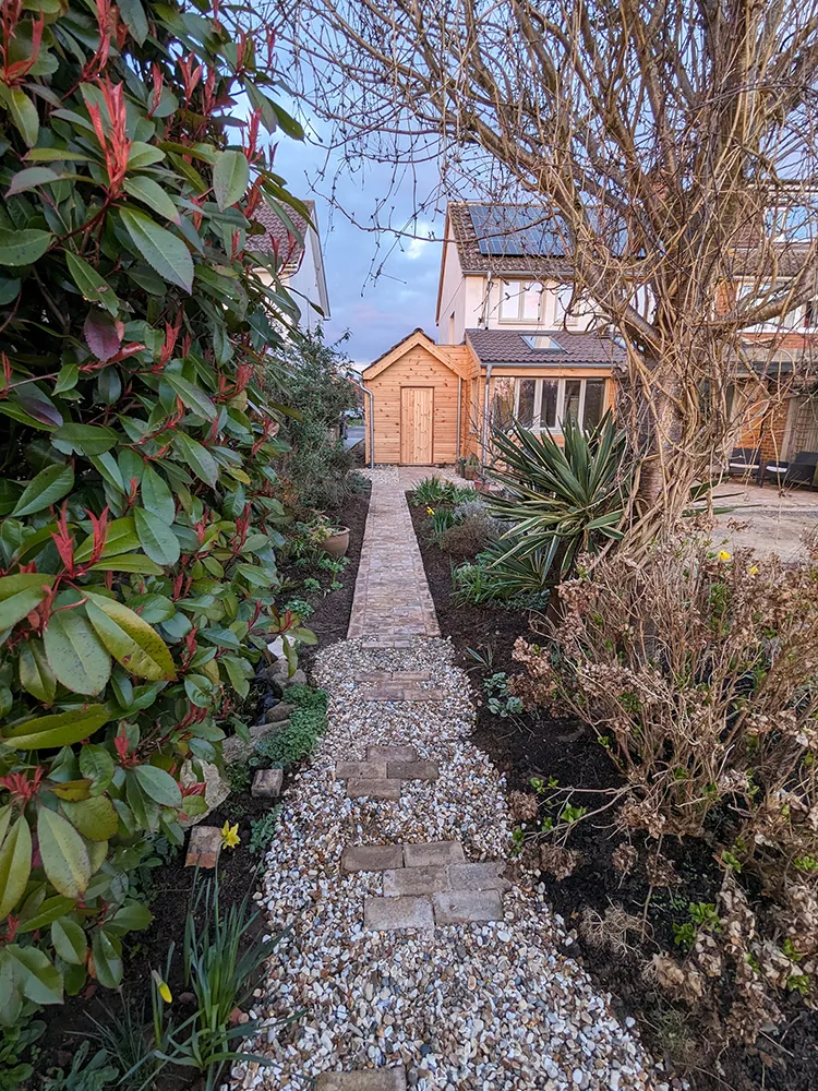 Block paved pathway down towards the house