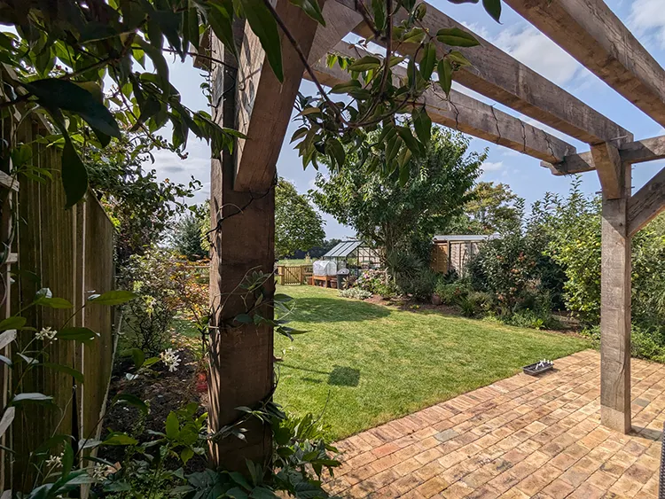 Pergola with established plants growing up around it