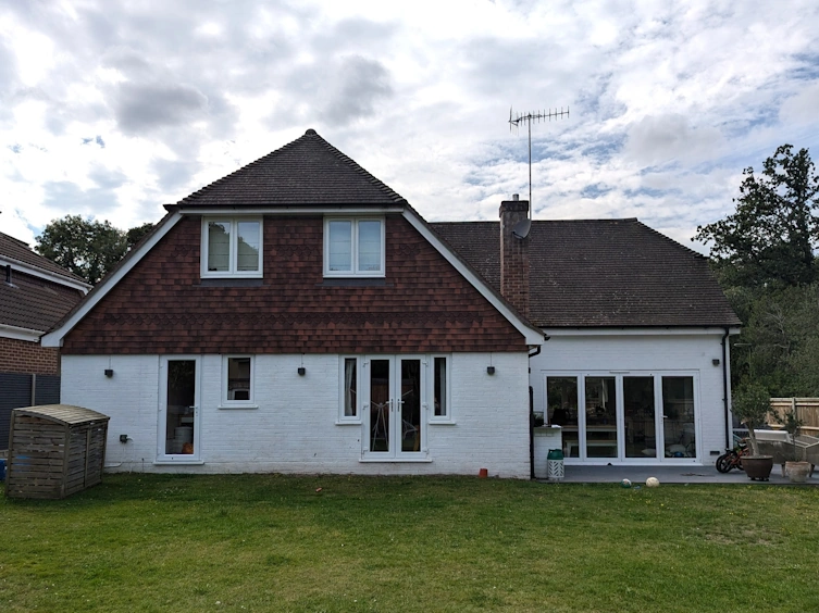 Before transformation - original simple lawn and small terrace in Farnham family garden
