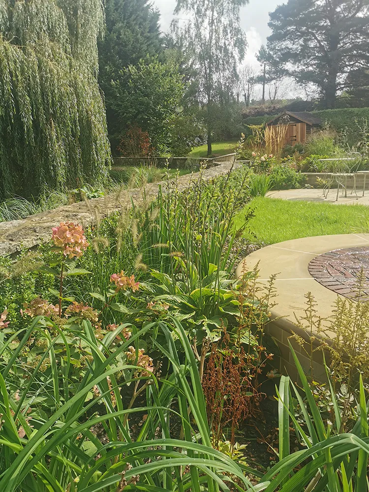 Sweeping planting around paving