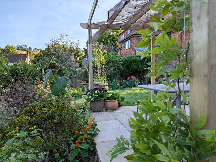 A terrace with a pergola over it