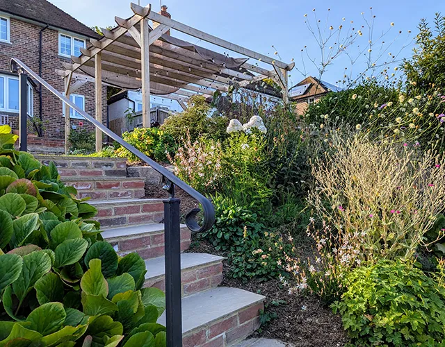 Garden on slop with pergola and patios