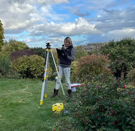 A photo of me undertaking a survey in a steep garden